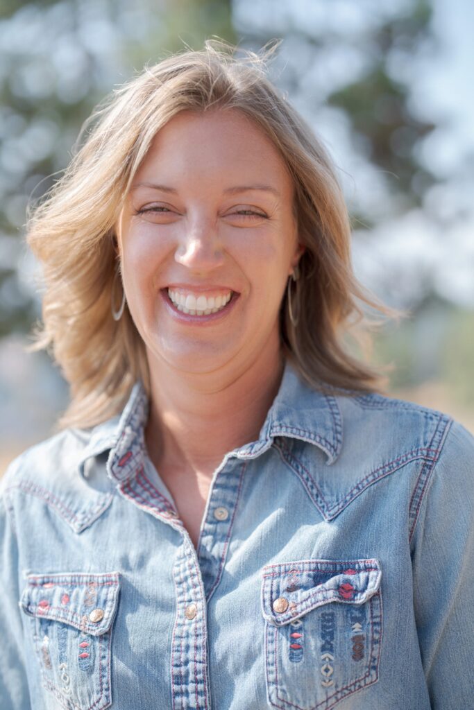 Middle-aged lady in a blue denim jeans jacket.