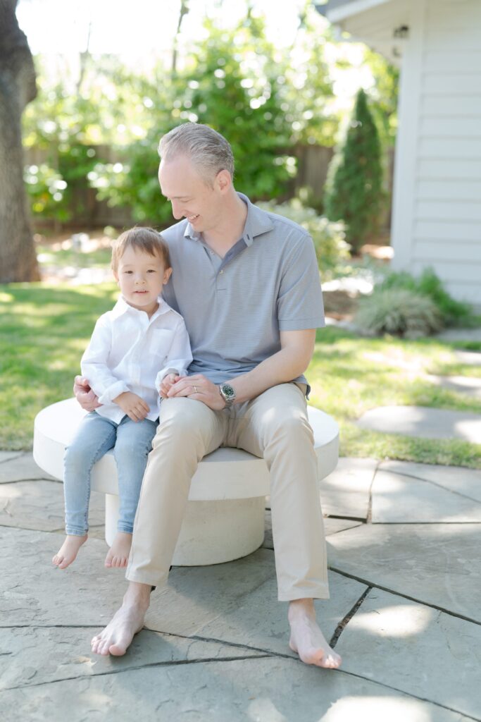 Proud father looks lovingly at his son.