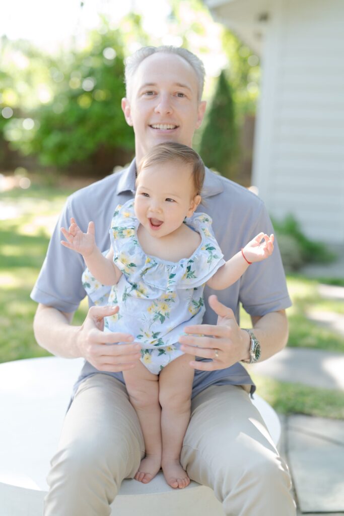 Happy dad holding his baby daughter.