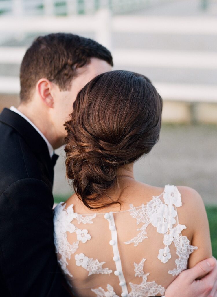 Beautiful wedding hairstyle and flowery see-through bridal dress.