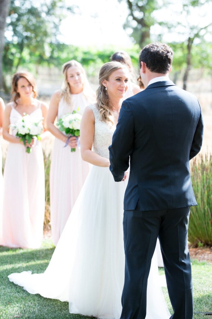color image of a bride looking at the groom durning the wedding ceremony. 