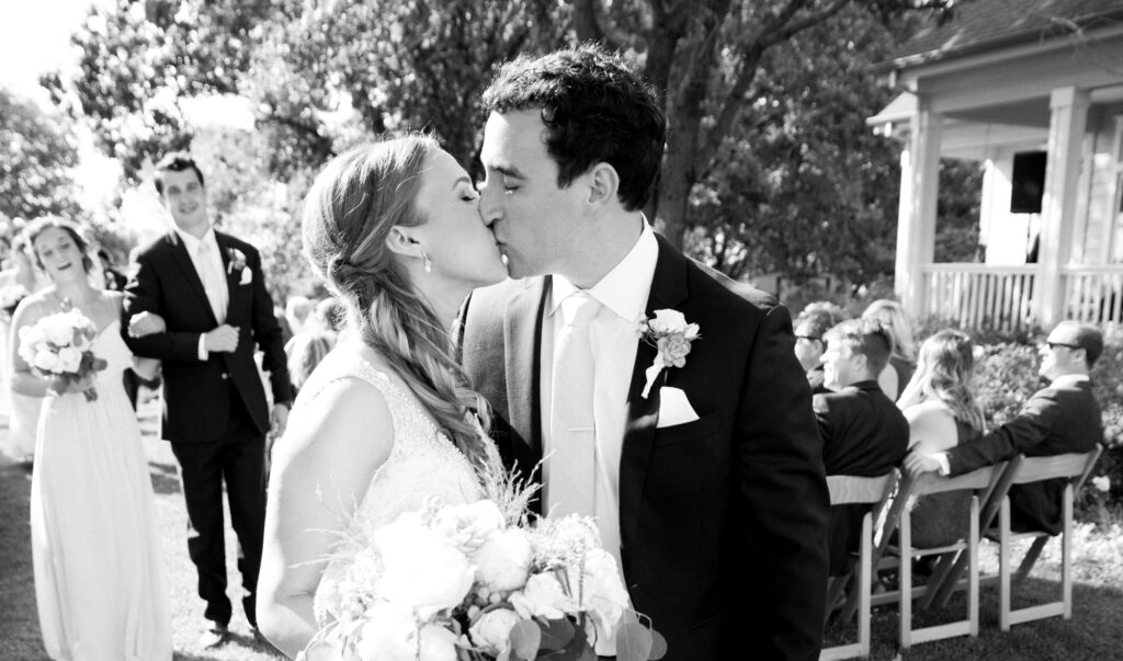 bride and groom kissing after their wedding ceremony. 
