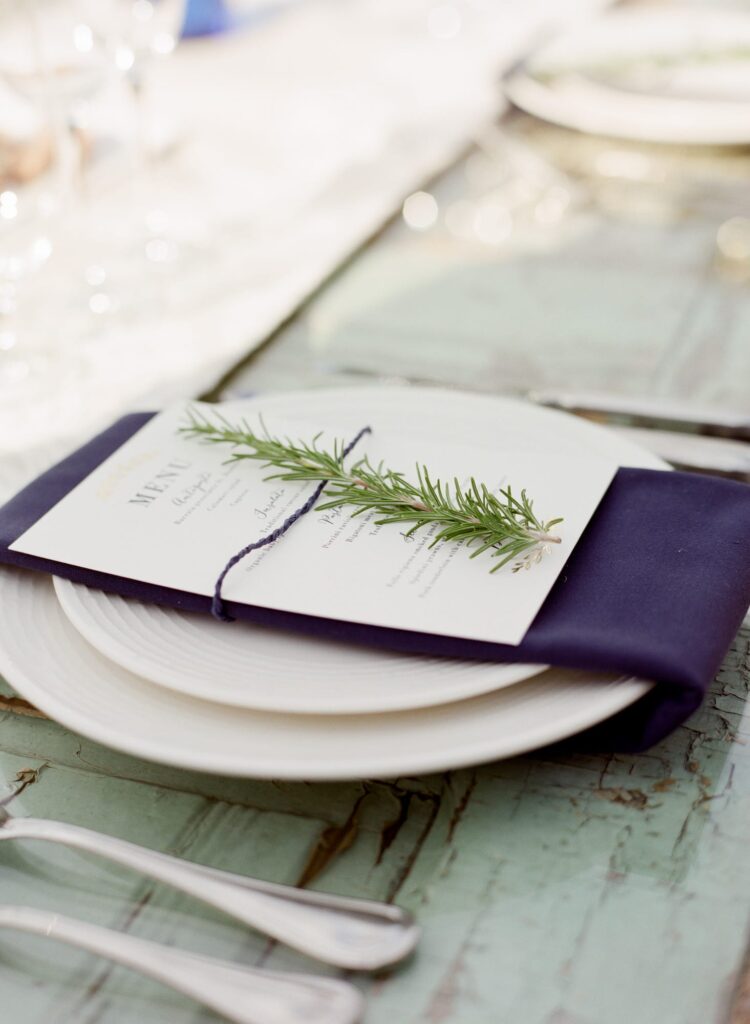 dinner menu with a sprig of rosemary