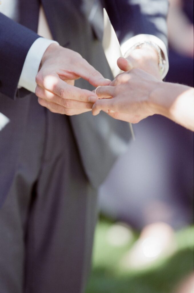 Wedding couple in Utah exchange rings.