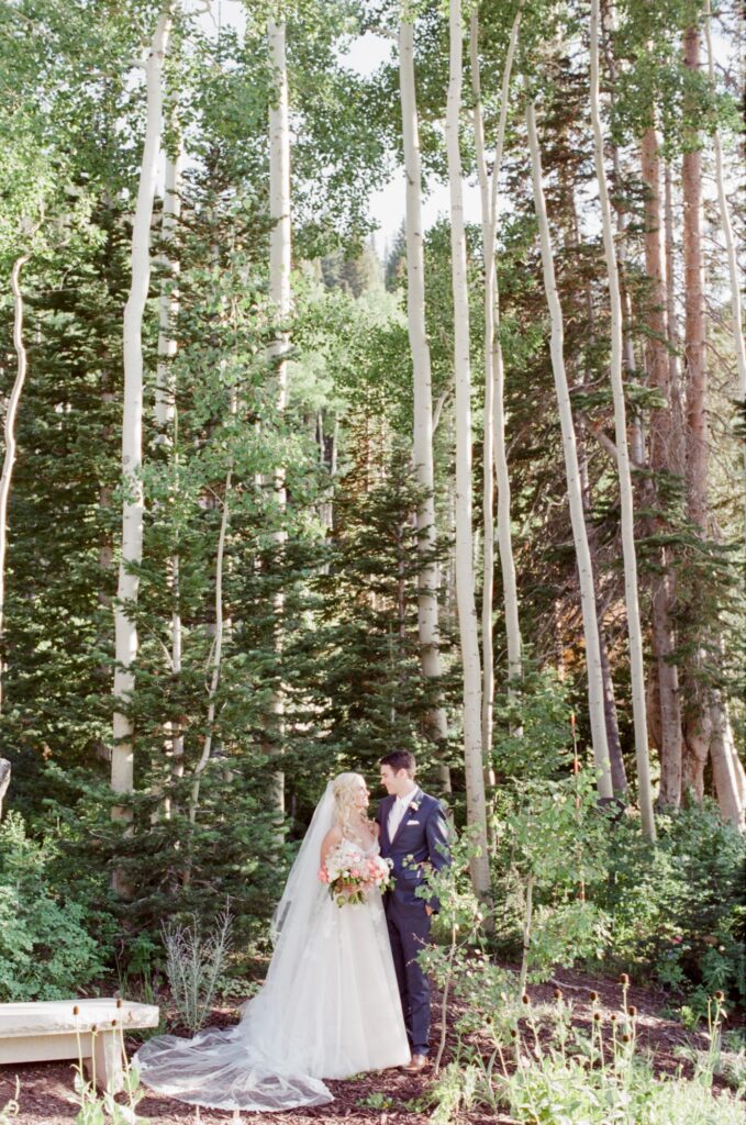 Bride and groom look at each other after a successful outdoor wedding in Park City, Utah.