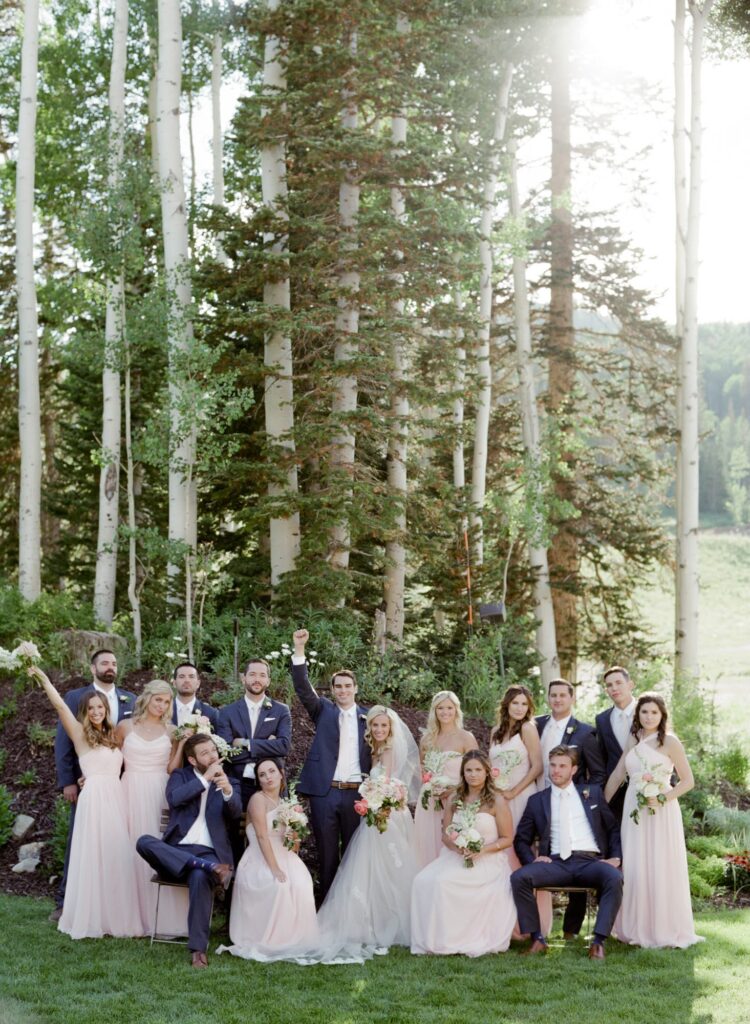 The bride, her bridesmaid, bridegroom, and his groomsmen commemorate the completion of a wedding ceremony in Park City.