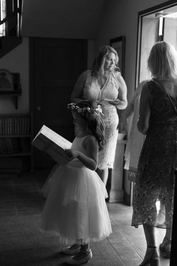 Cute little girl imitates the officiator as a wedding guest.