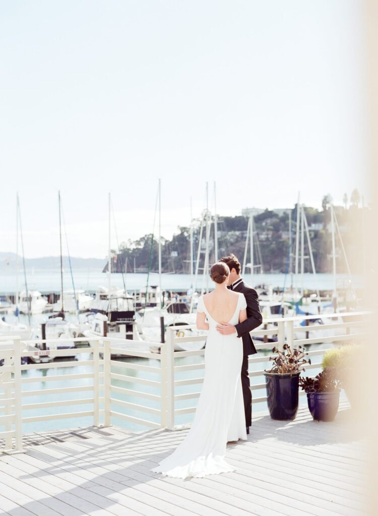 Bride and groom come together at the Tiburon harbor.