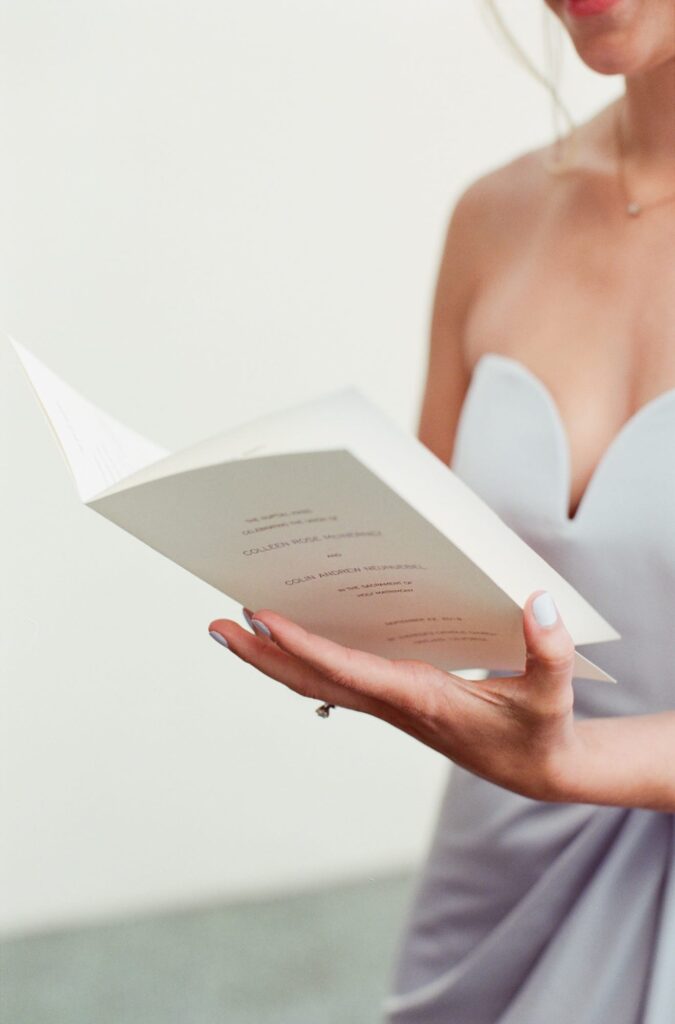 Bridesmaid looks at the wedding invitation card.