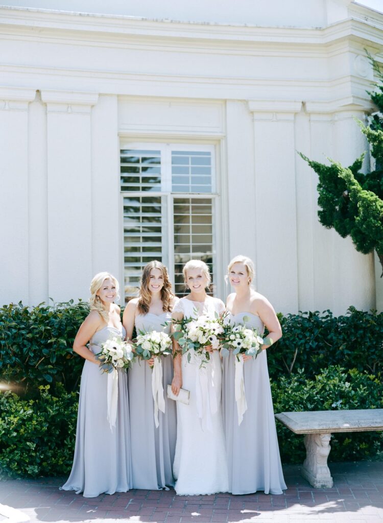 Bride clicks a picture with her bridesmaids.