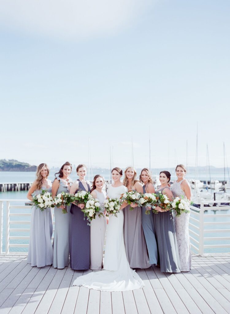 Bride poses with her bridesmaids at the Tiburon harbor.