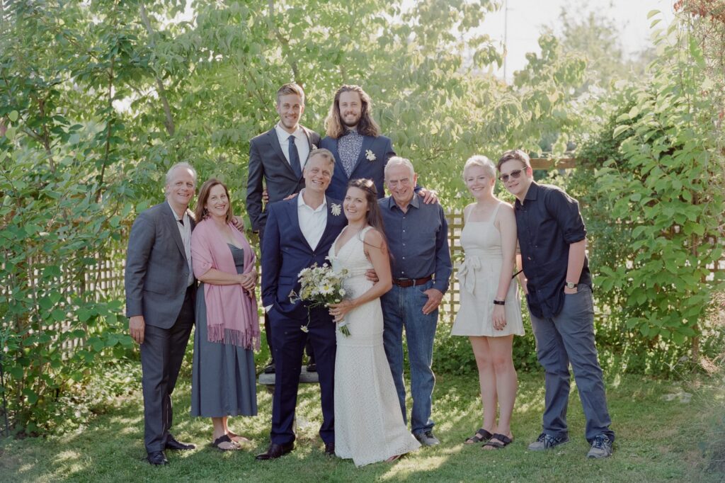 Bride and groom pose with their family.