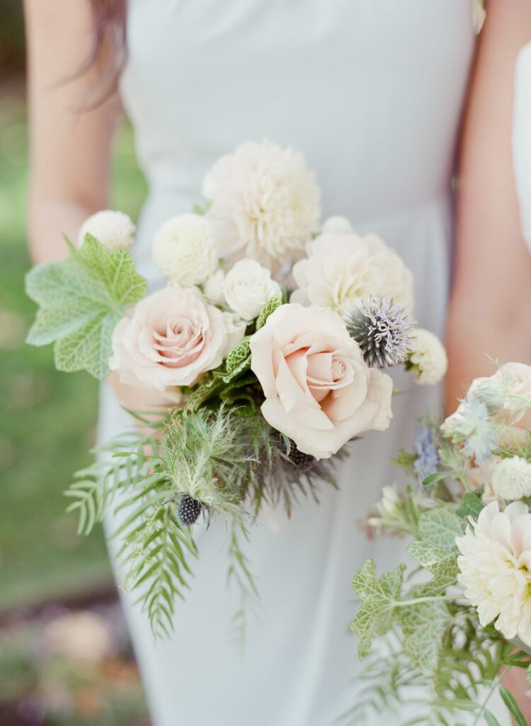 Lady in a beautiful dress holds a bouquet of flowers.