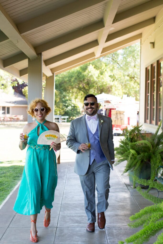 Colorfully dressed couple guests attend the wedding.