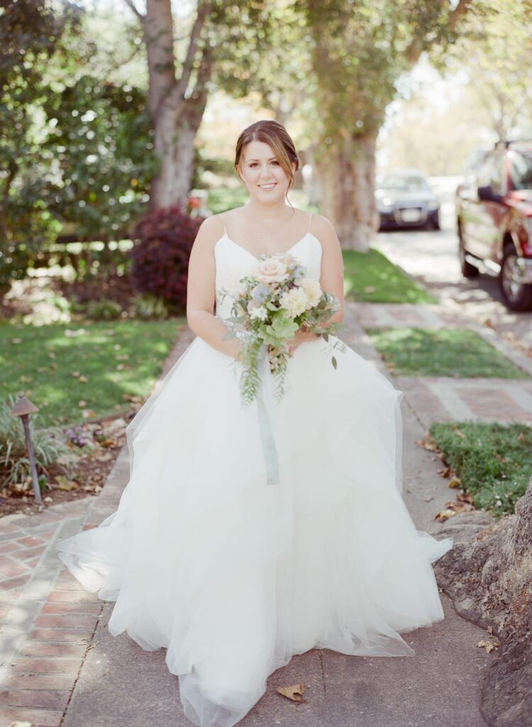 Piedmont Wedding bride in white wedding gown holds a bouquet.