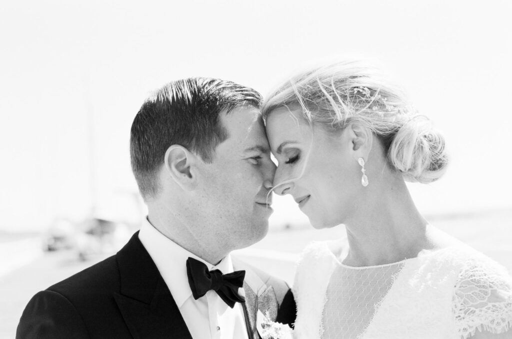 Bride and groom lean in for a kiss.