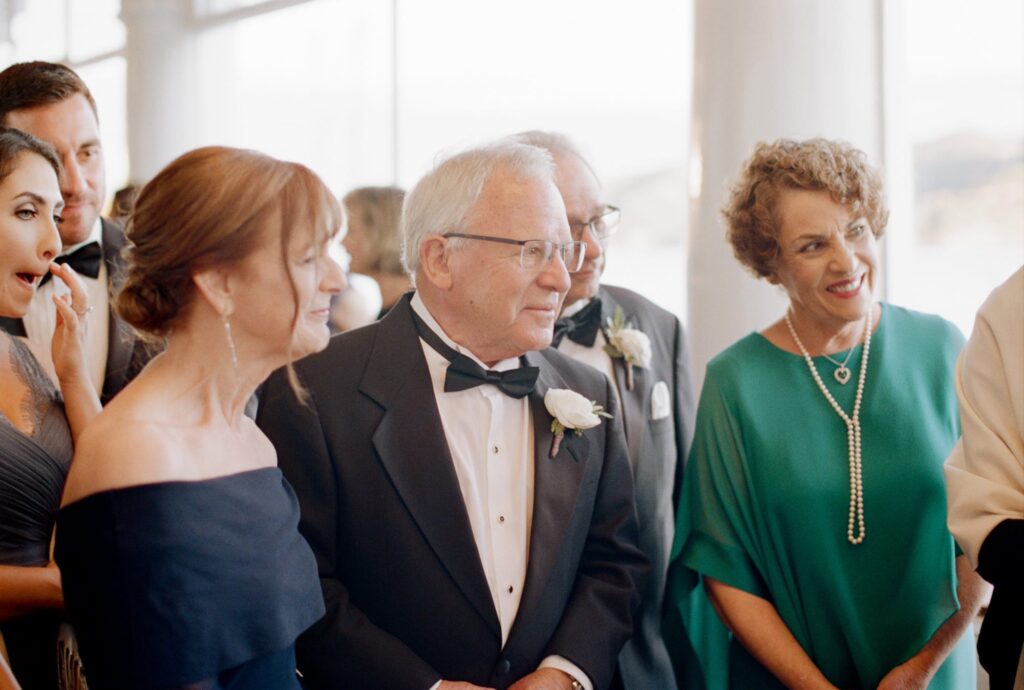 Elderly guests attend the officiation ceremony at a wedding.