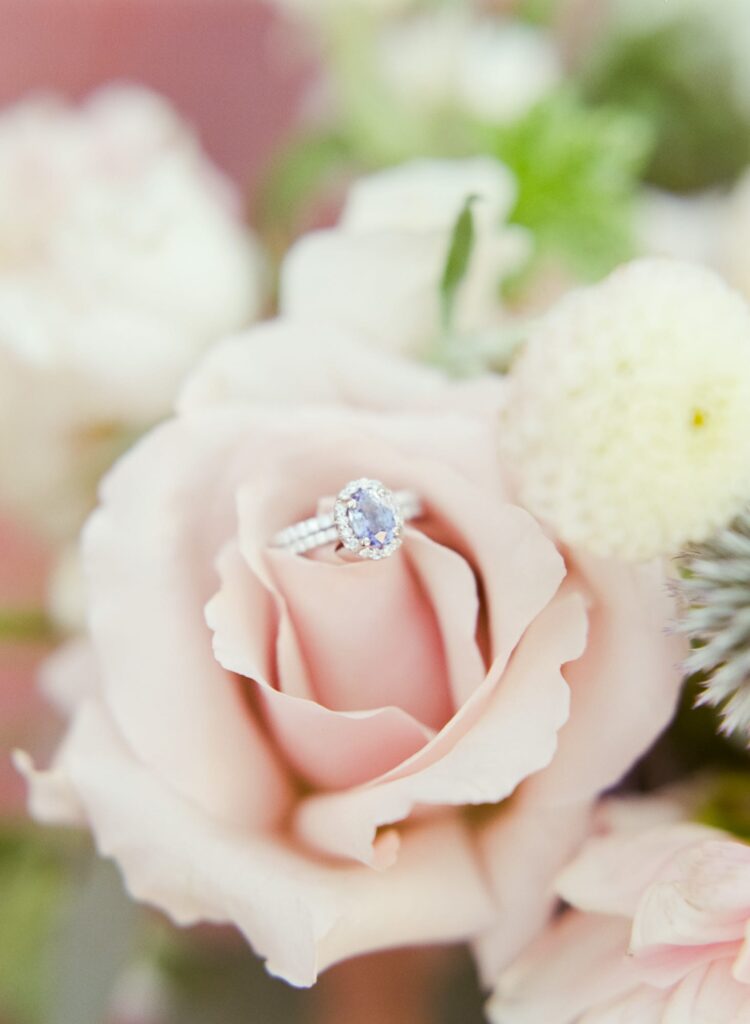 Beautiful wedding ring for the bride placed on a rose flower.