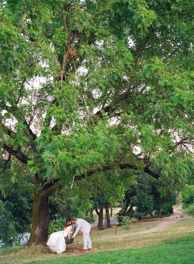 Magazine style wedding photography of a newly married couple in the swing.