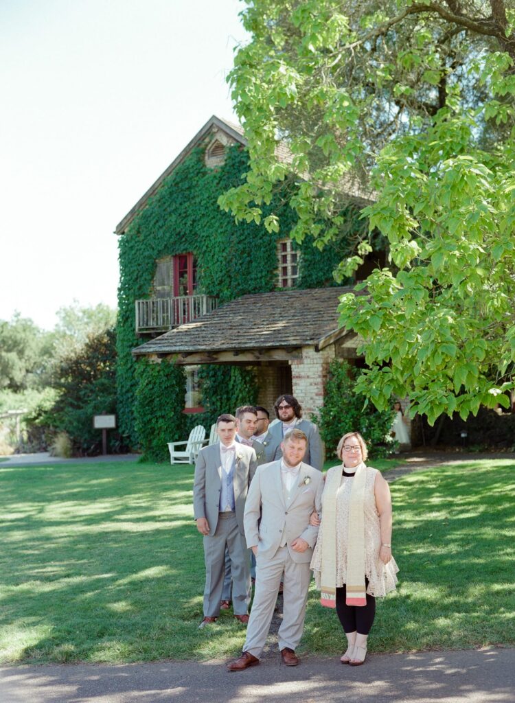 Groom with his mom and groomsmen at his wedding.