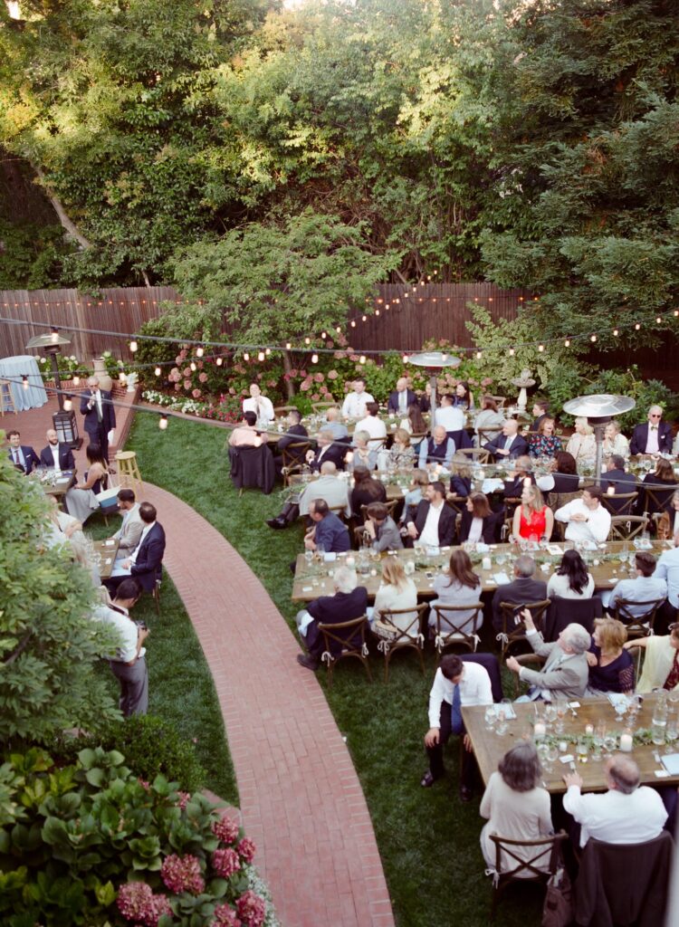 Evening wedding reception party venue with guests seated at the table.