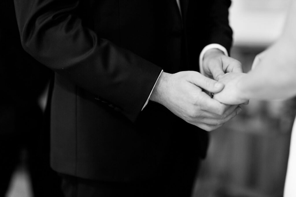 Groom holds the bride's hand.