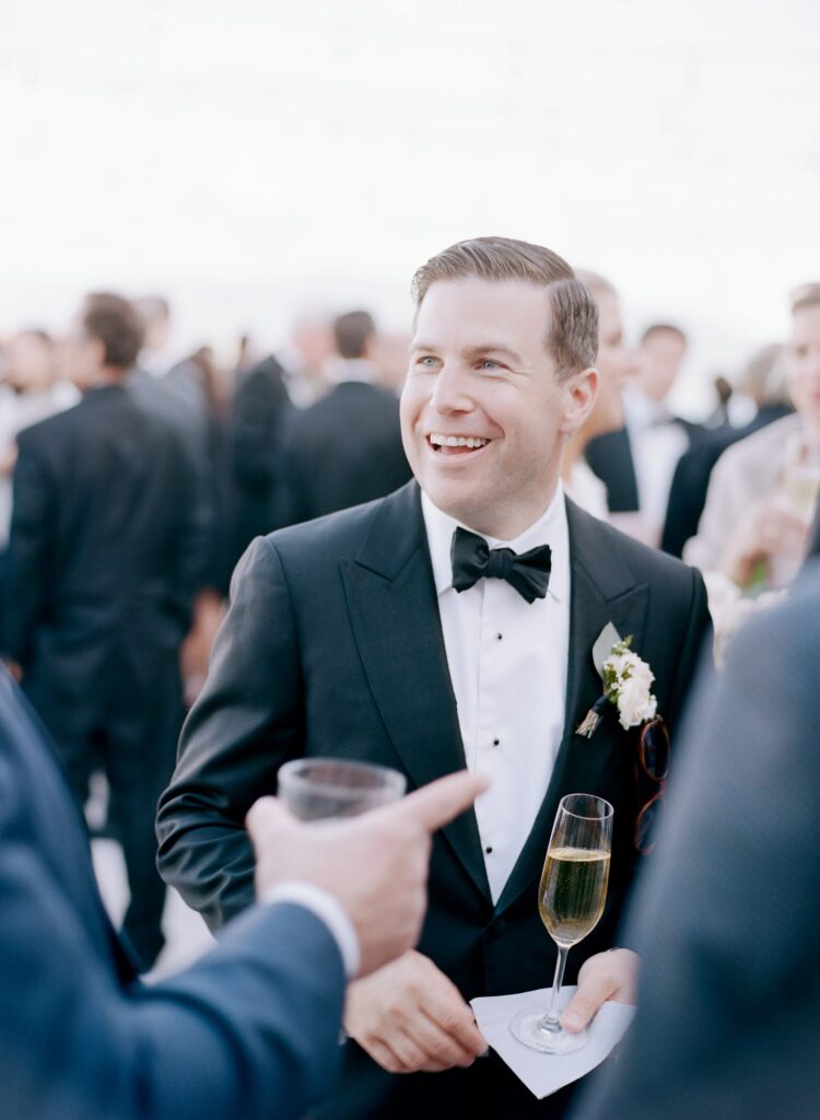 Bride drinks champagne and entertains his wedding guests.