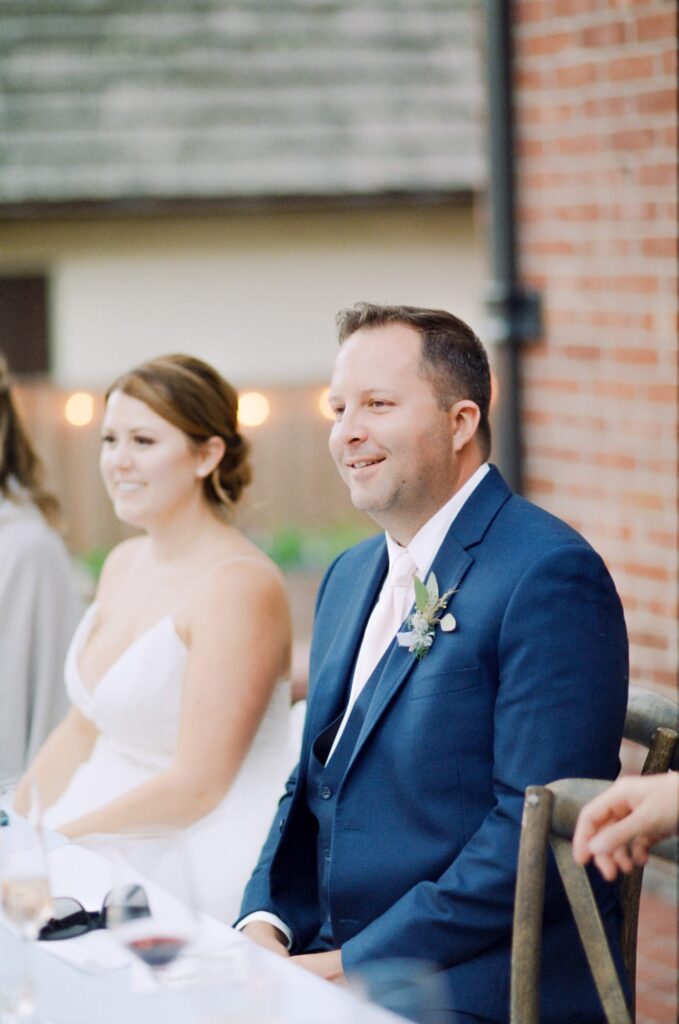 Bride and groom seated at the table for their Piedmont wedding reception party.