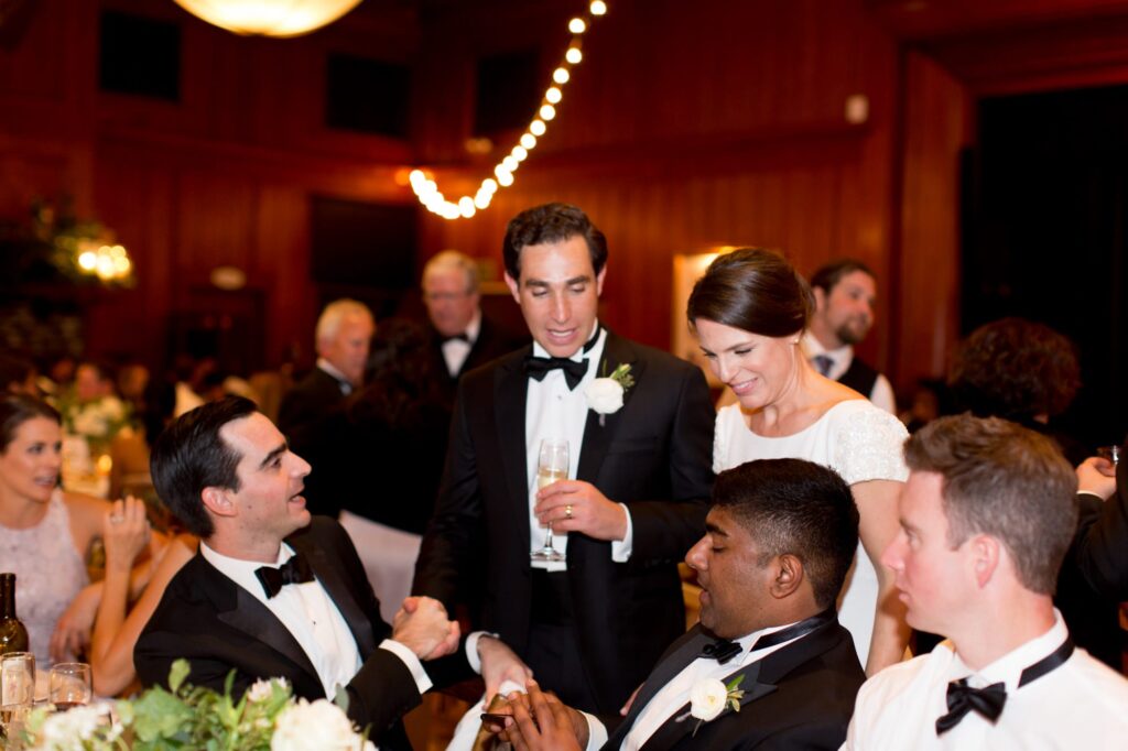 Newlyweds interact with their wedding guests.