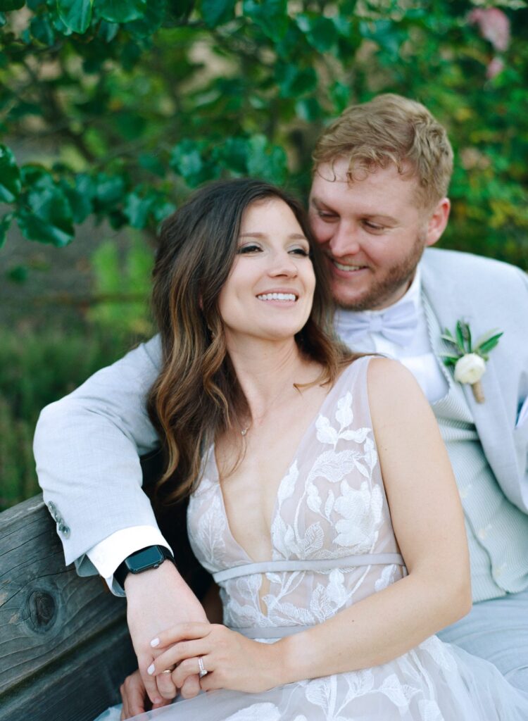 Elegantly dressed bride and groom embrace after their big wedding day.