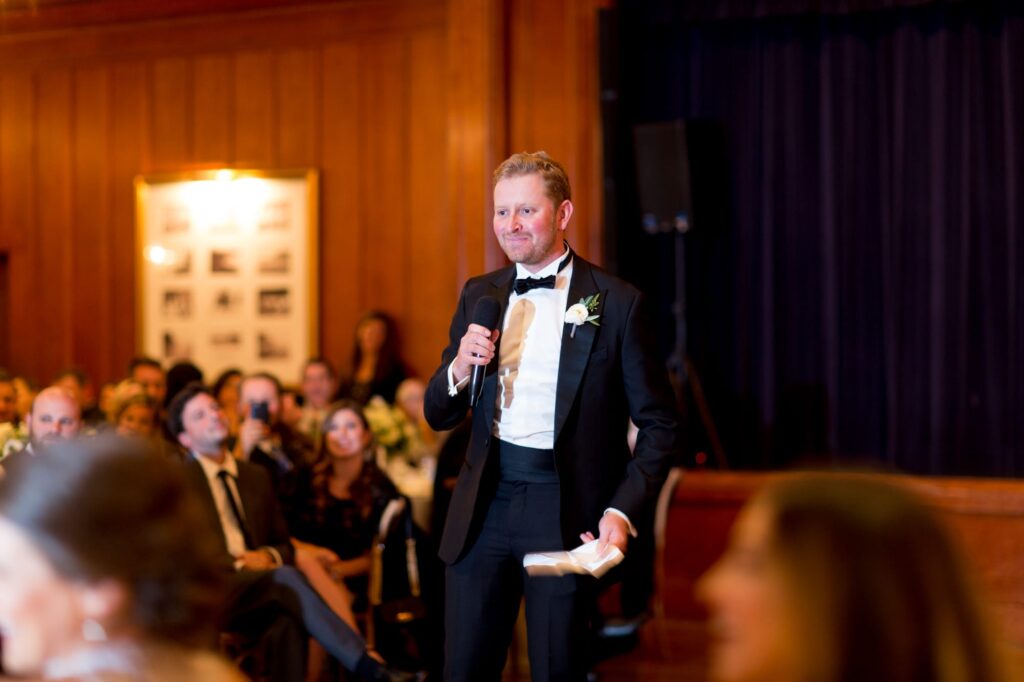 Wedding guest raises a toast for the newlyweds.