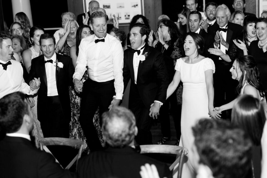 Bride and groom dance with wedding guests in their traditional dance.