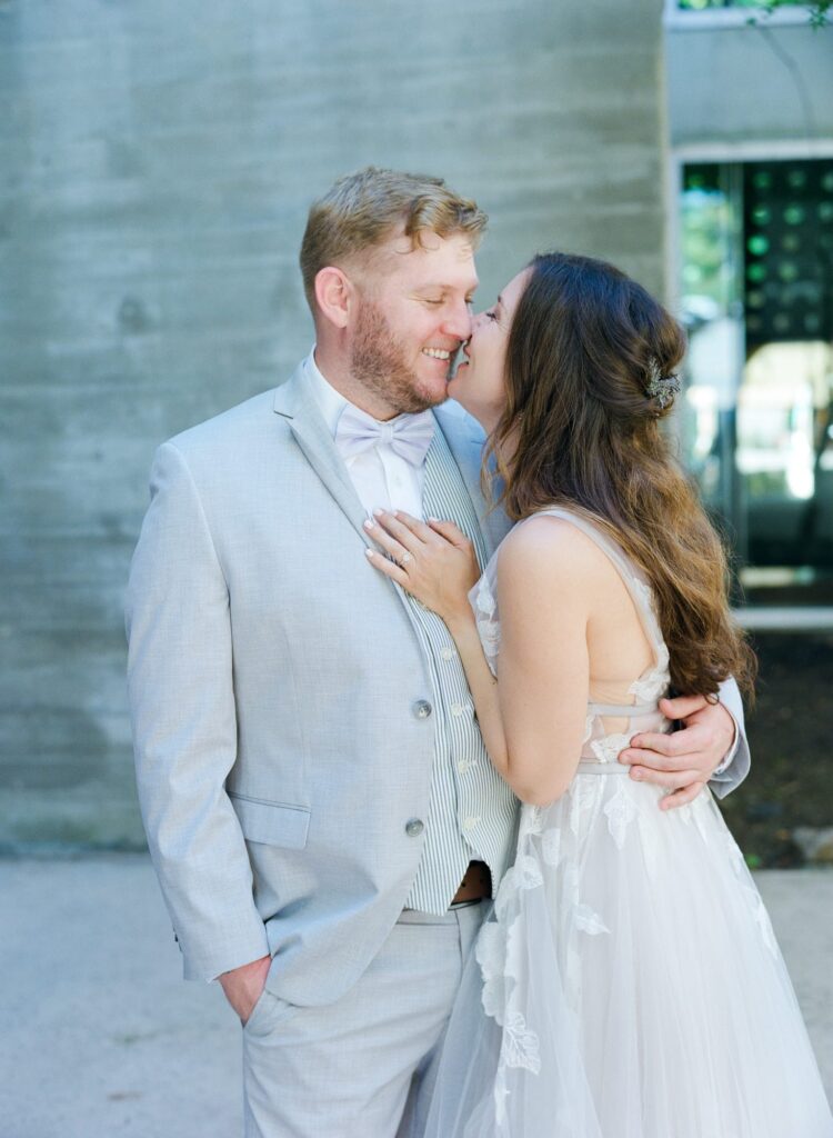 Bride kisses her newly-married husband.