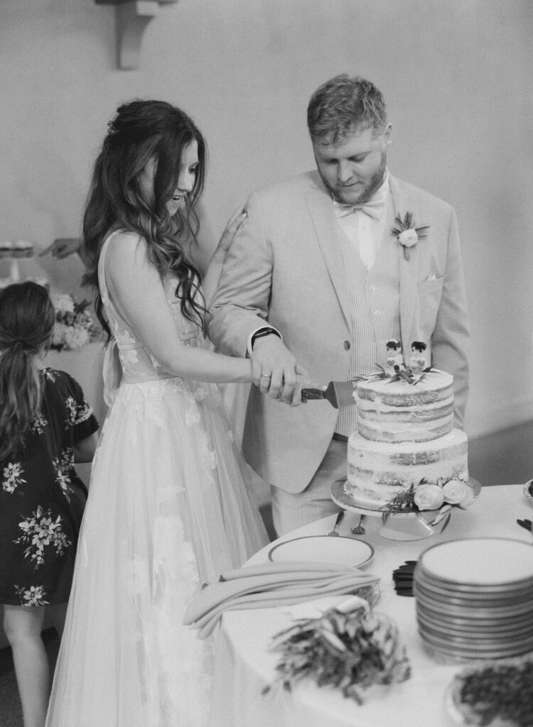 Bride and groom cut their wedding cake.