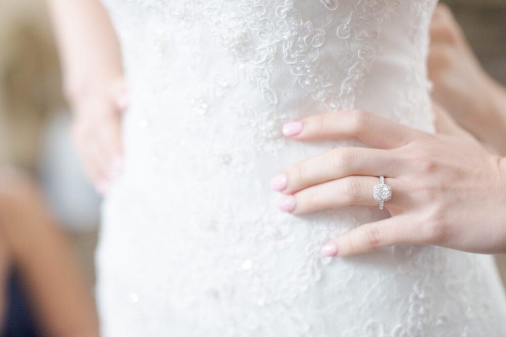 Bride in wedding gown and her engagement ring.