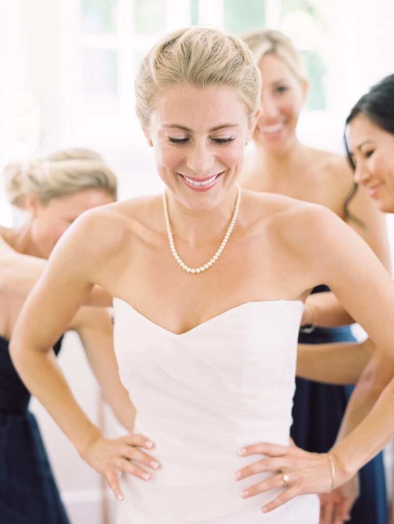 Bridesmaids prepare the bride-to-be for her wedding ceremony.