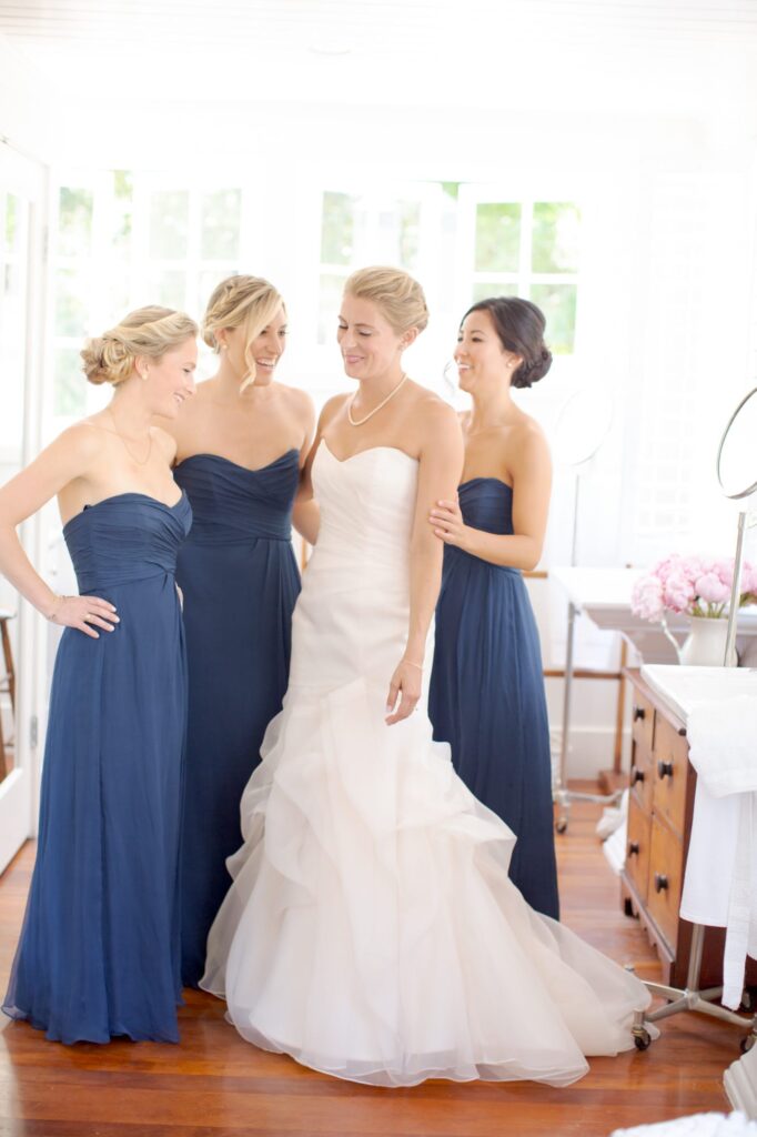 Bridesmaids have a fun moment with the bride.