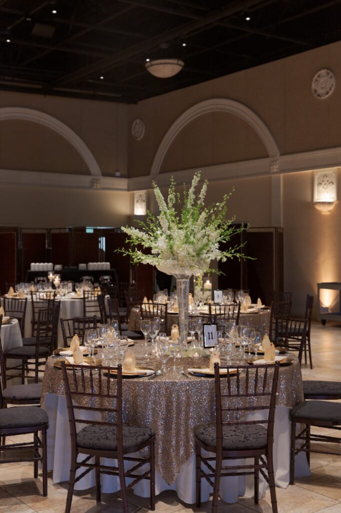 Champagne glasses and cutlery placed on tables for the afterparty.