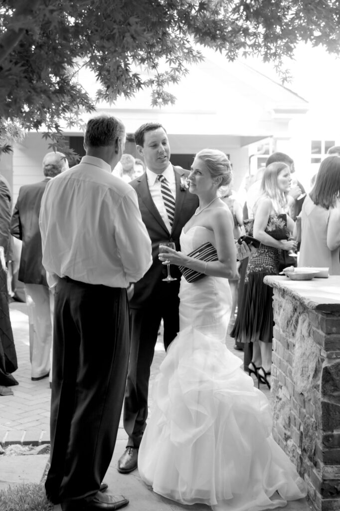 Bride and groom interact with their wedding guest.