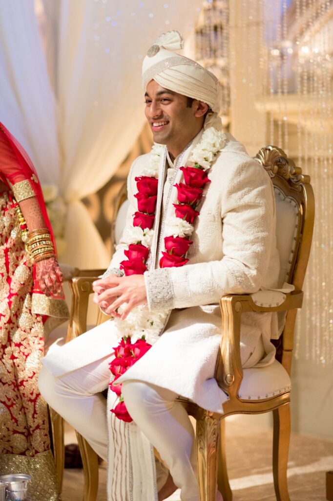 Bridegroom with a garland of roses at an Indian-style wedding ceremony.