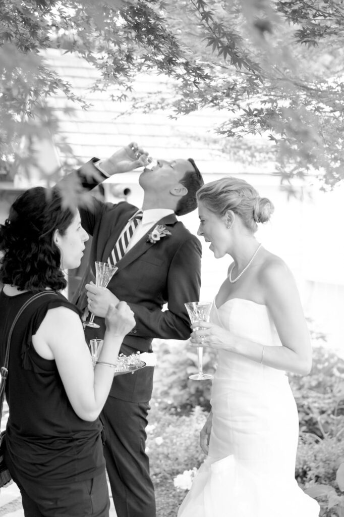 New bridegroom celebrates his union with champagne.