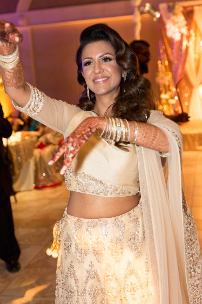 Beautiful bride does Indian-style dance at her wedding party.