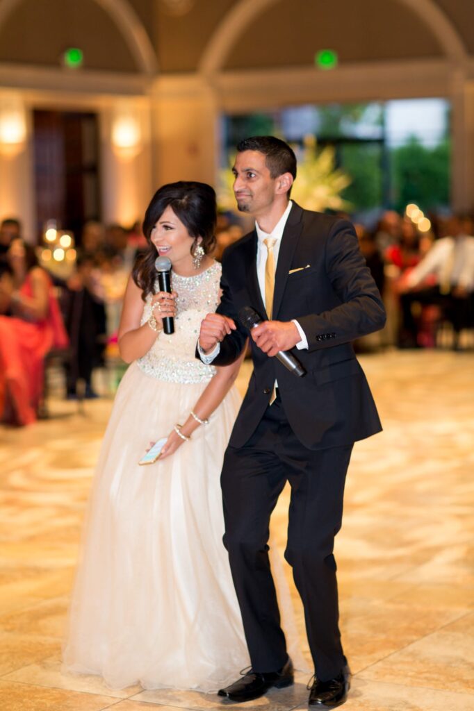 Friends of the bride and groom address the reception party guests.