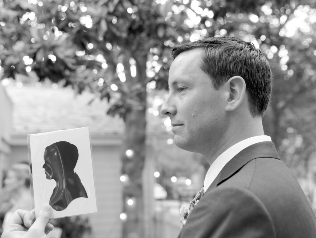 Backyard wedding portrait of the groom in suit and tie.