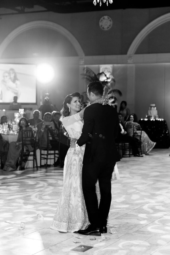 Newly married bride and groom dance together.