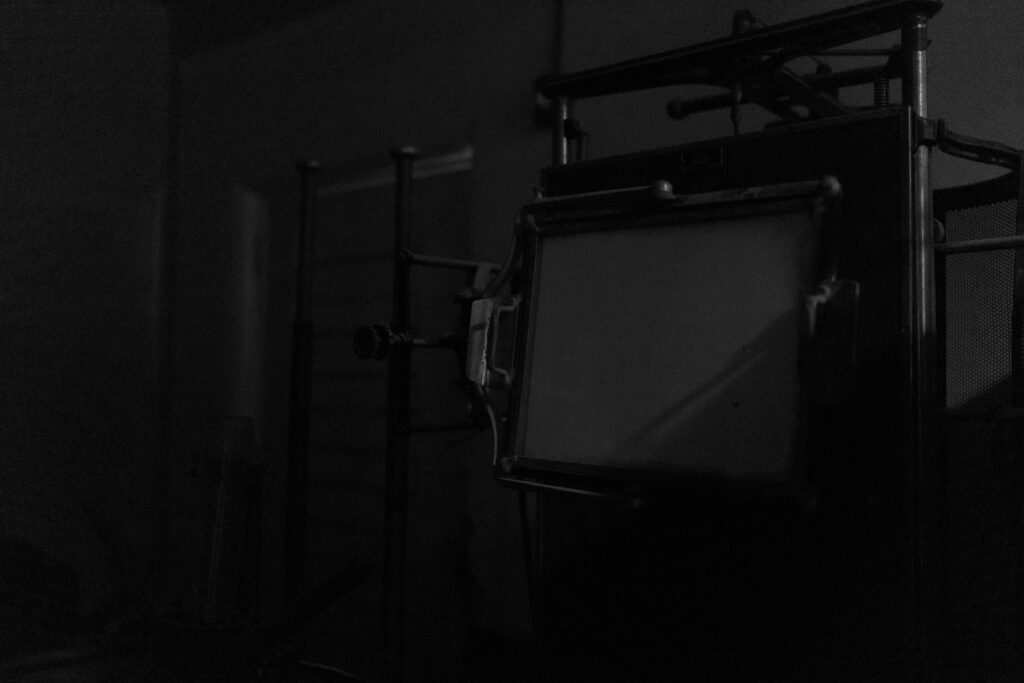 A very dark room with an old, vintage piece of equipment.