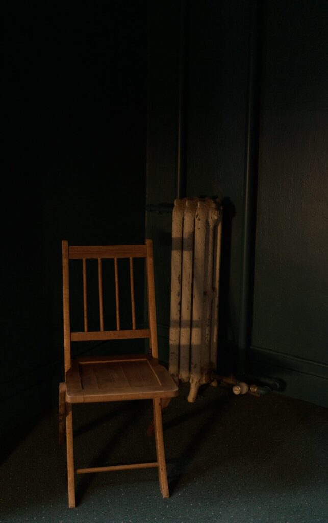 Soft sunlight falls on a vintage wooden chair