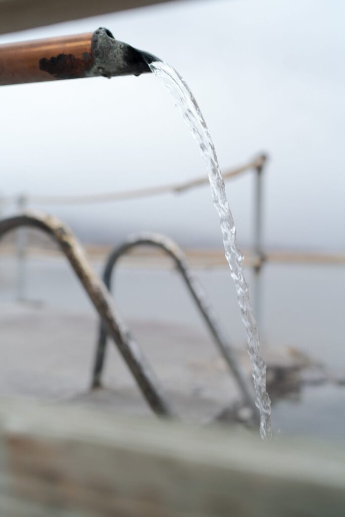 Water flows through a metal sprout at Hot Lake Springs.