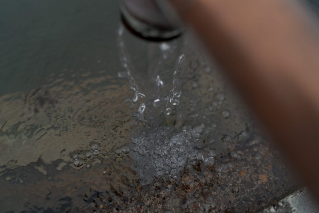 Close-up of water flowing into a reservoir.