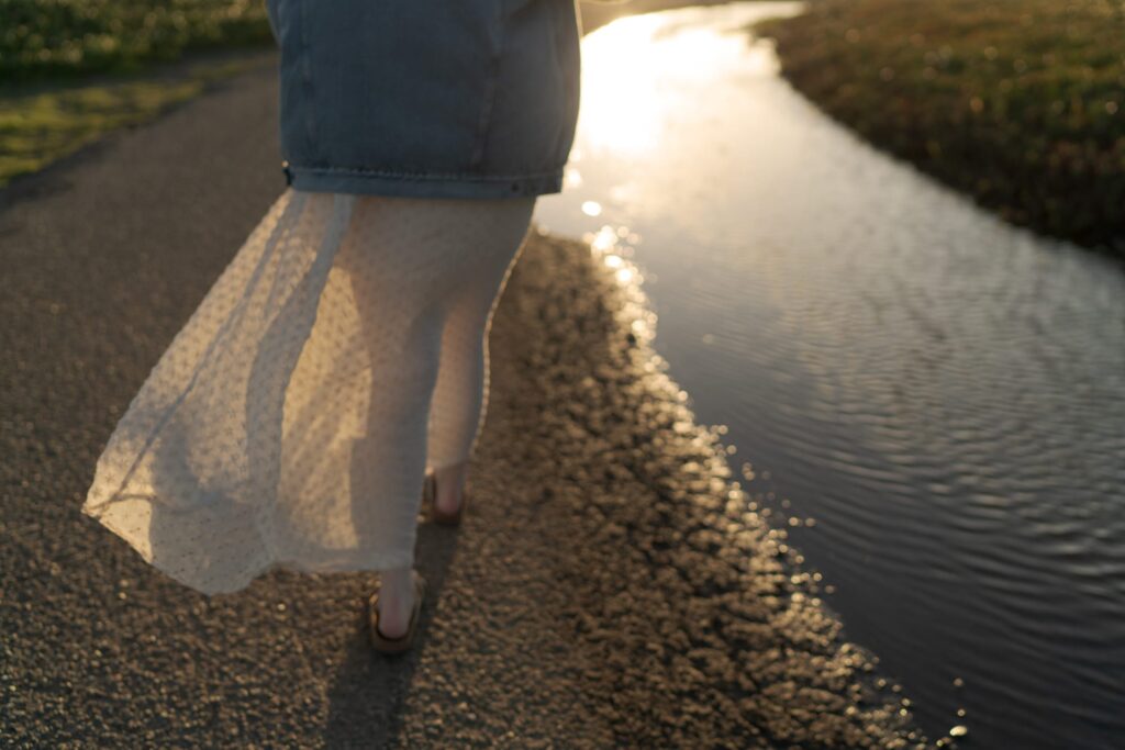 Warm yellow sunlight falls on translucent gown.